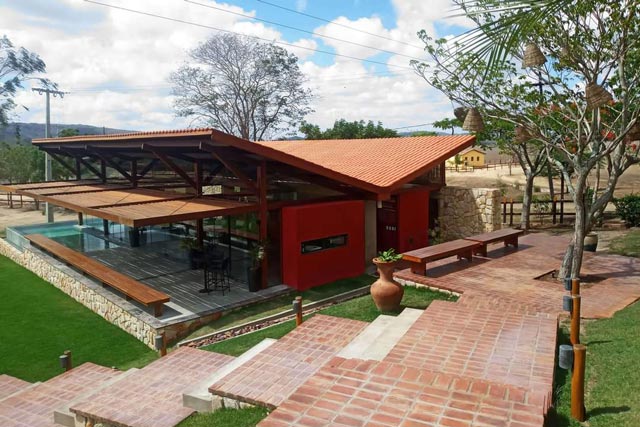 Uma casa onde o uso da madeira se destaca priorizando a ideia da Arquitetura nos Trópicos 